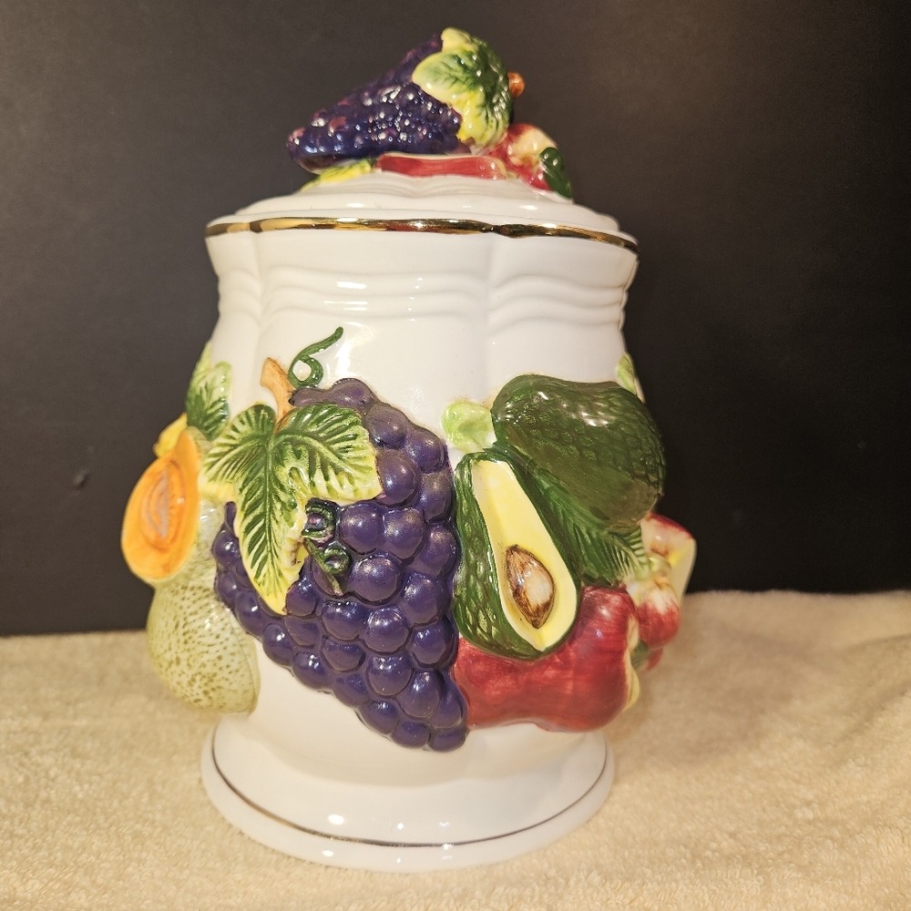 KMC large ceramic food storage canister with a colorful fruit motif.